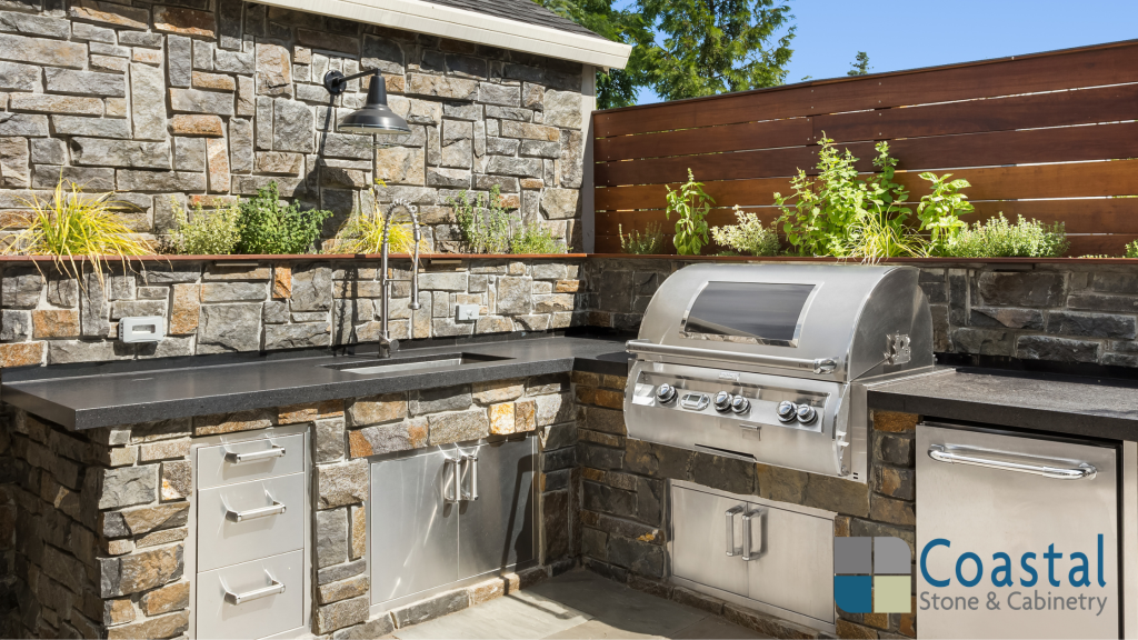 Outdoor kitchen with granite countertops and coastal backsplash tile design in a Fairhope home