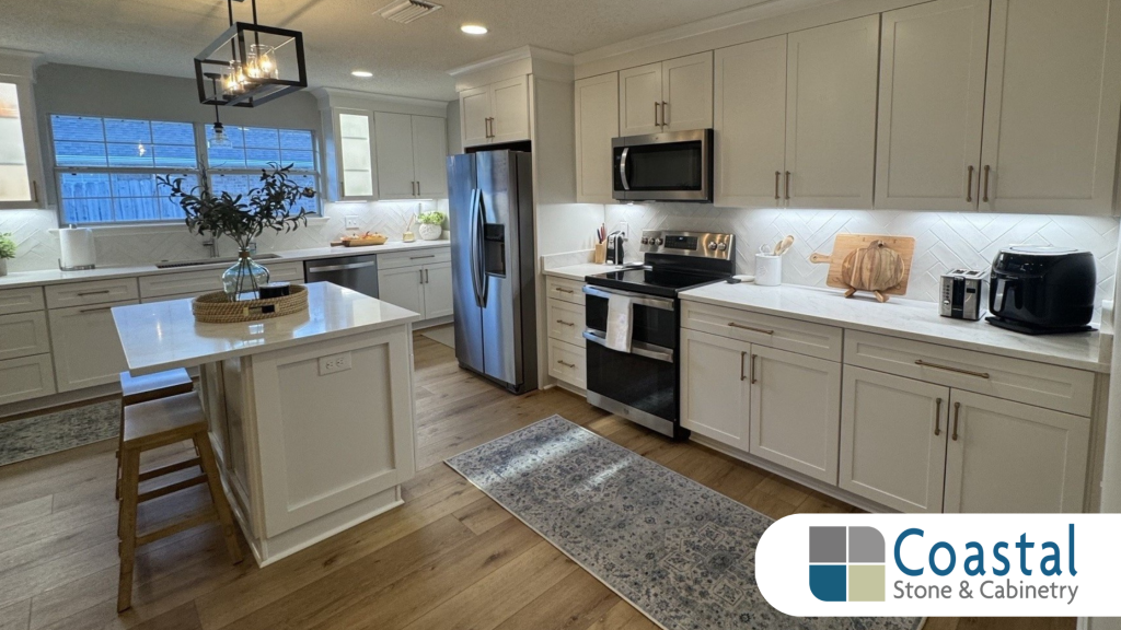 Modern kitchen with white customizable cabinets, stainless steel appliances and bright countertops designed by Coastal Stone and Cabinetry.